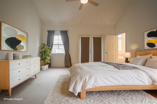 bedroom featuring light carpet, high vaulted ceiling, and ceiling fan