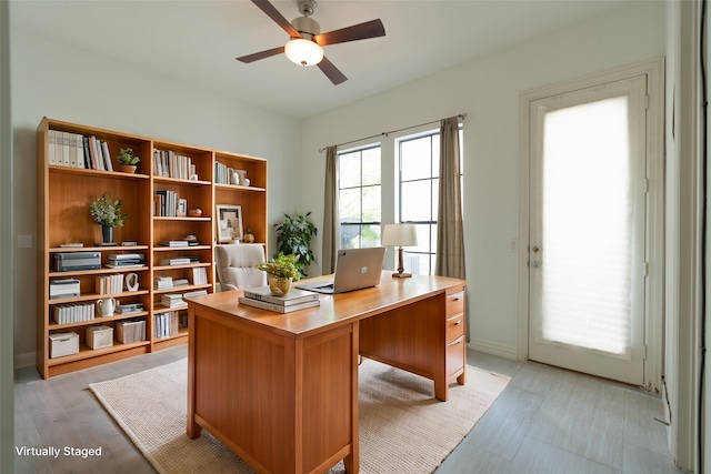 office space with light wood-type flooring and ceiling fan