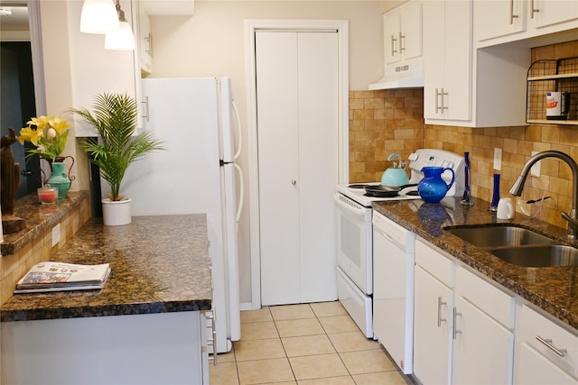 kitchen featuring pendant lighting, white cabinetry, custom range hood, and sink