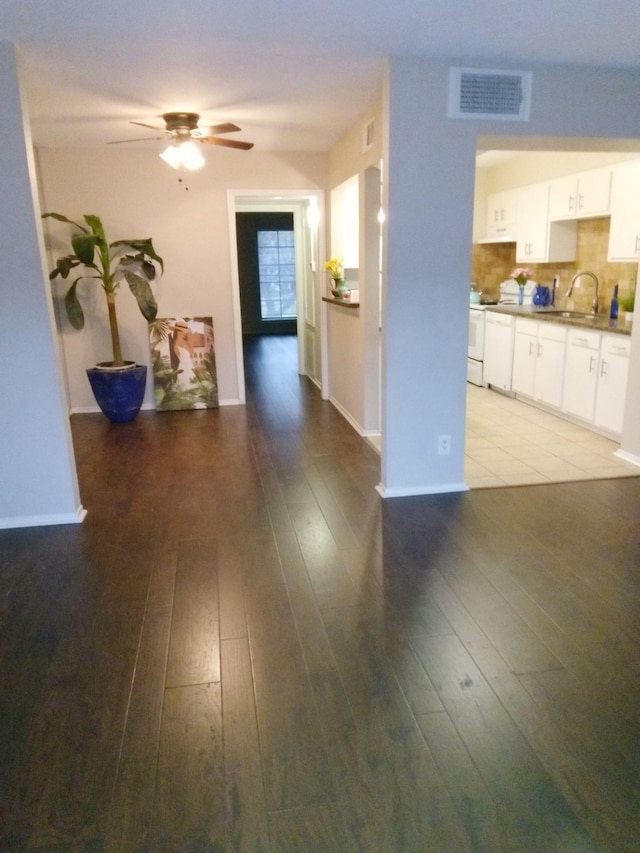 hallway featuring light wood-type flooring and sink