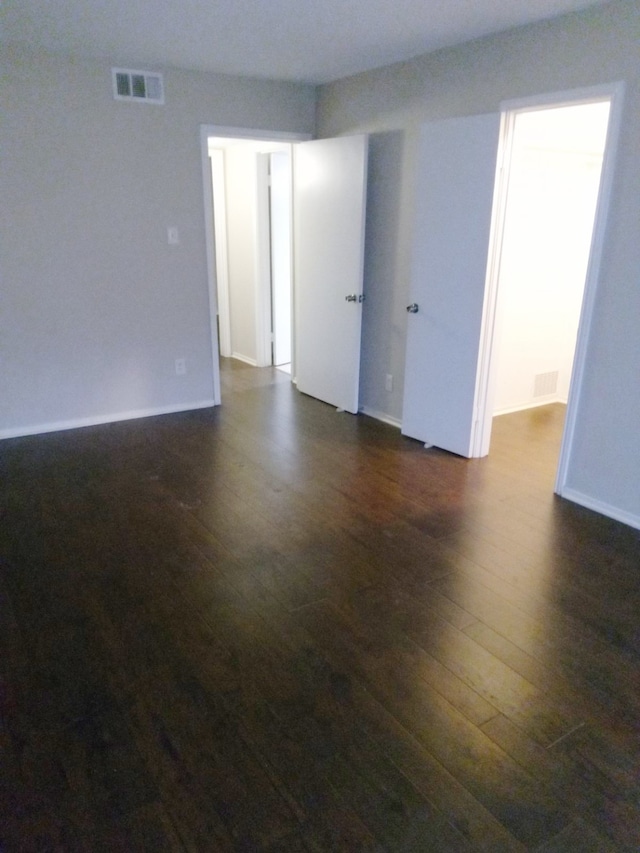 unfurnished room featuring dark hardwood / wood-style flooring