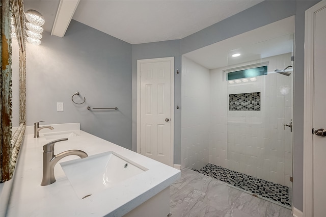 bathroom featuring vanity and tiled shower