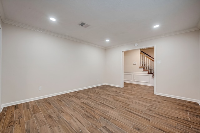 spare room with wood-type flooring and ornamental molding