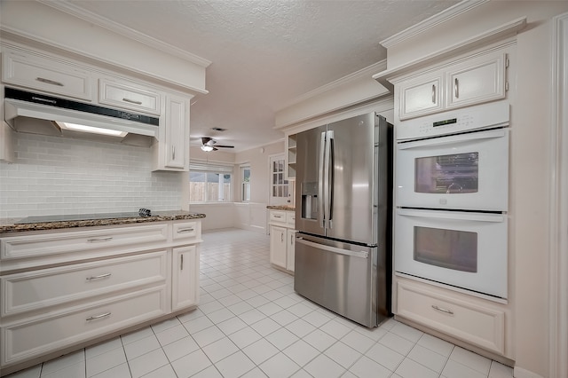 kitchen with stainless steel refrigerator with ice dispenser, stone counters, white double oven, and ceiling fan