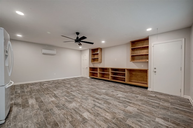 unfurnished living room with ceiling fan, hardwood / wood-style floors, and a wall mounted air conditioner