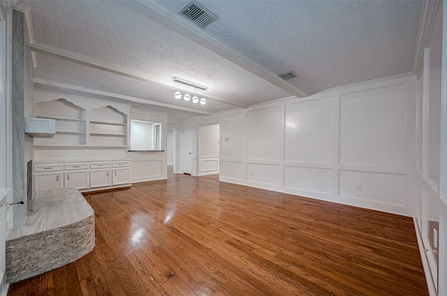 interior space featuring a textured ceiling, wood-type flooring, and built in shelves