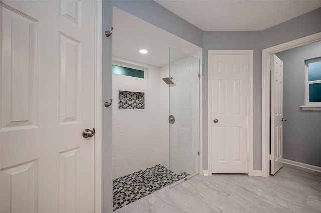 bathroom featuring a tile shower