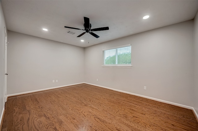 empty room featuring hardwood / wood-style floors and ceiling fan