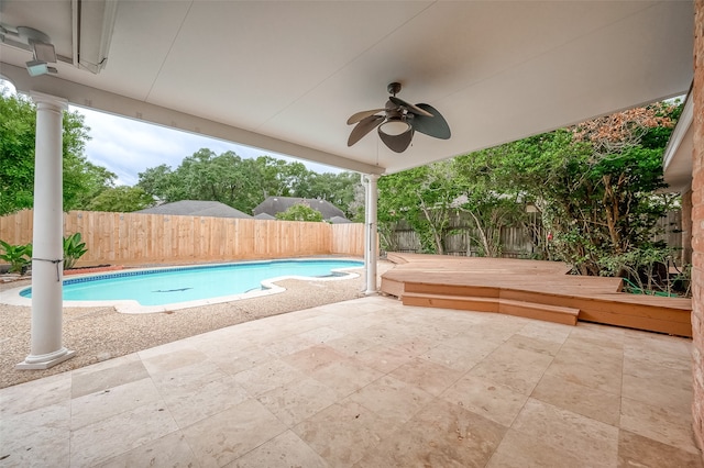 view of swimming pool with a patio area, ceiling fan, and a wooden deck