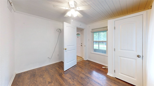 unfurnished bedroom with ceiling fan, crown molding, dark hardwood / wood-style flooring, and wooden ceiling