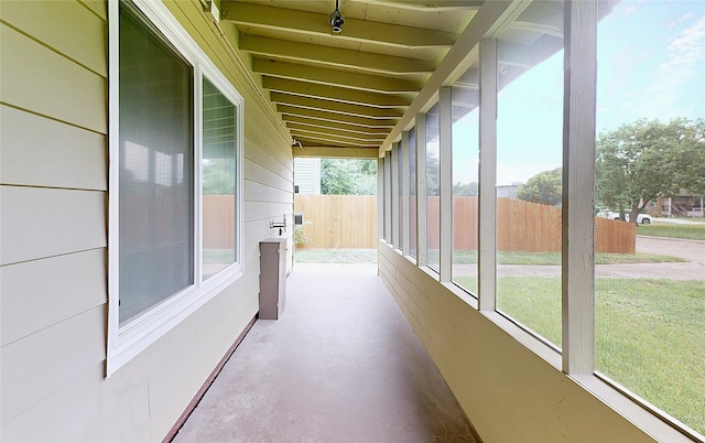 unfurnished sunroom featuring vaulted ceiling