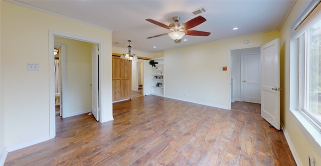 empty room featuring crown molding, ceiling fan, and hardwood / wood-style flooring