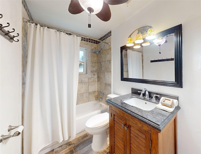 full bathroom with ceiling fan, vanity, wood-type flooring, toilet, and shower / tub combo with curtain