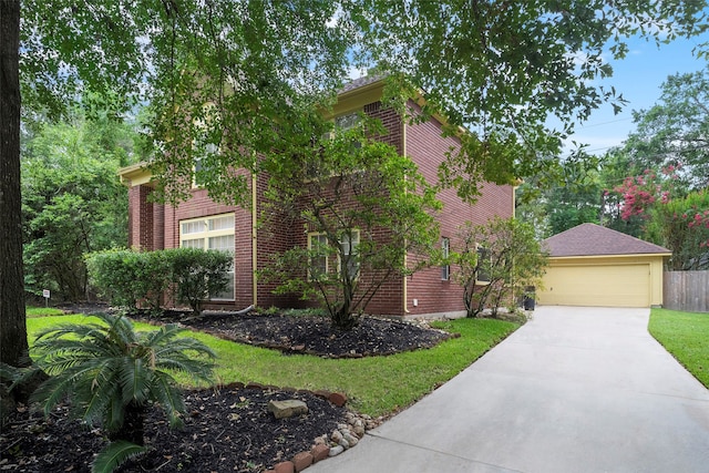 view of front of home featuring a garage and a front lawn