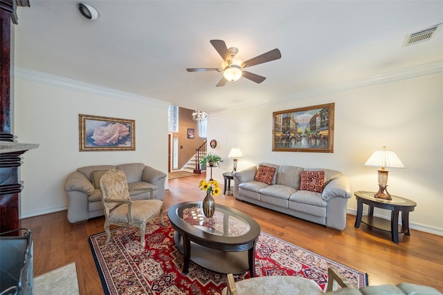 living room with ornamental molding, hardwood / wood-style floors, and ceiling fan