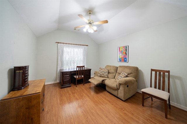 living room with light wood-type flooring, vaulted ceiling, and ceiling fan