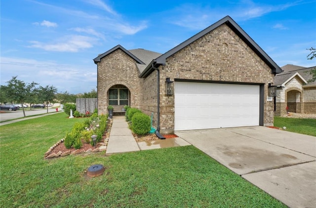 view of front of house featuring a front yard and a garage