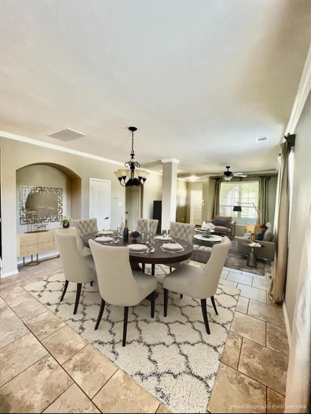 dining room with ornamental molding and ceiling fan with notable chandelier