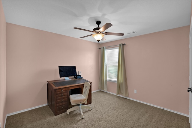 carpeted office space featuring ceiling fan