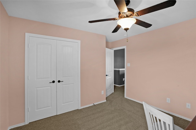 unfurnished bedroom featuring light carpet, a closet, and ceiling fan