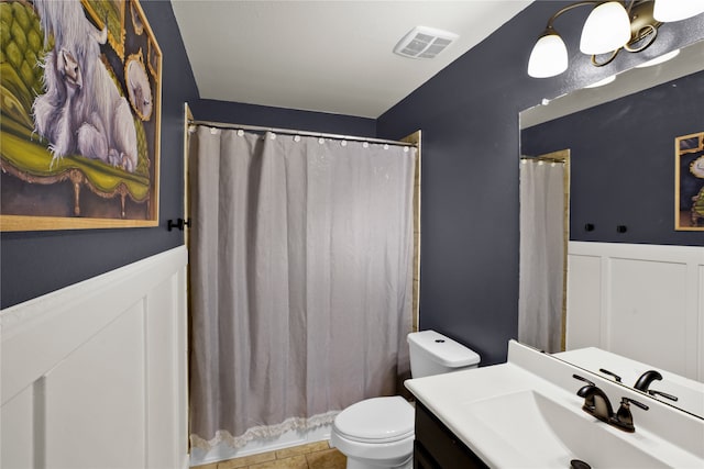 bathroom featuring vanity, toilet, walk in shower, and tile patterned flooring