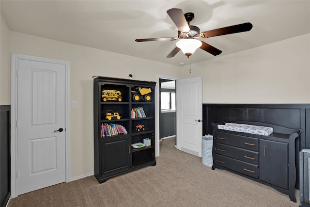 bedroom featuring light colored carpet and ceiling fan