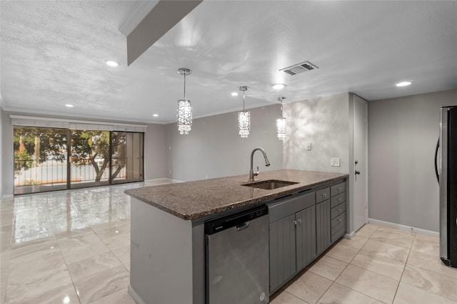 kitchen featuring dark stone counters, sink, hanging light fixtures, a textured ceiling, and stainless steel appliances