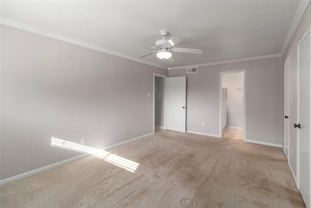 unfurnished bedroom featuring ceiling fan, light colored carpet, crown molding, and connected bathroom