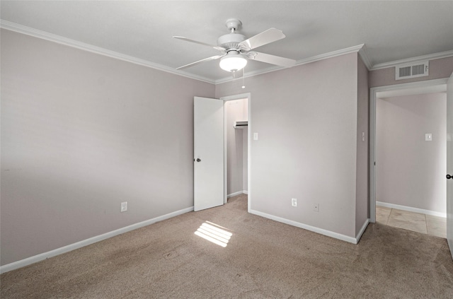 carpeted spare room featuring ceiling fan and ornamental molding