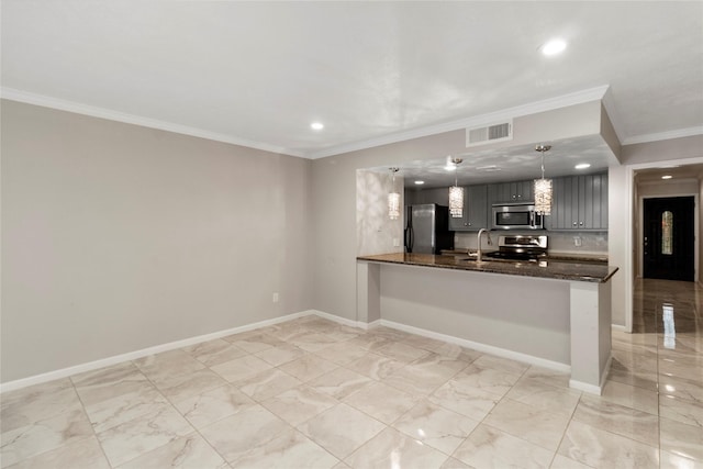 kitchen with pendant lighting, gray cabinetry, dark stone counters, appliances with stainless steel finishes, and kitchen peninsula