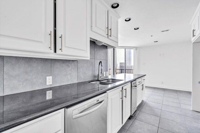 kitchen with dishwasher, white cabinets, and a sink