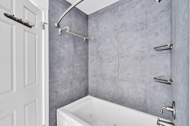 bathroom with a combined bath / shower with jetted tub