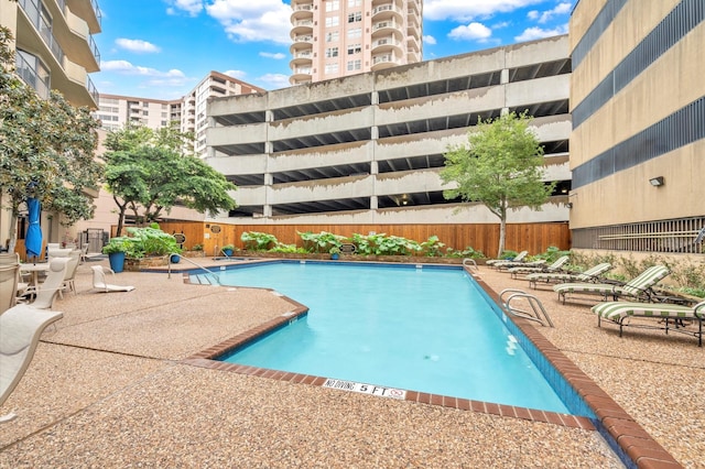 pool featuring a fenced backyard and a patio