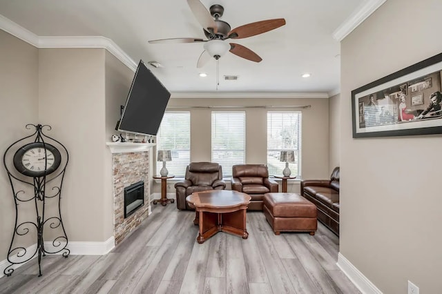 sitting room featuring a fireplace, a wealth of natural light, light hardwood / wood-style flooring, and ceiling fan