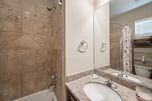 full bathroom featuring vanity, shower / bath combo with shower curtain, and toilet