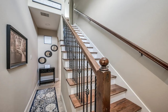 stairway featuring tile patterned flooring