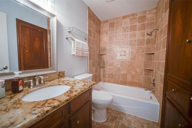 full bathroom featuring vanity, toilet, and tiled shower / bath