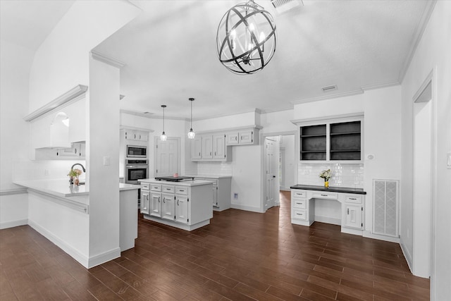 kitchen with dark wood-type flooring, stainless steel appliances, and white cabinets