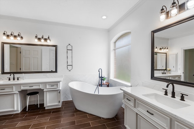 bathroom with ornamental molding, vanity, and a bath