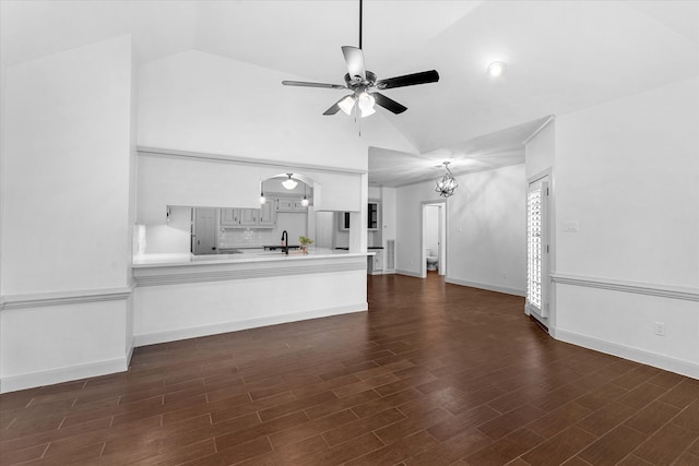 unfurnished living room featuring dark wood-type flooring, lofted ceiling, sink, and ceiling fan