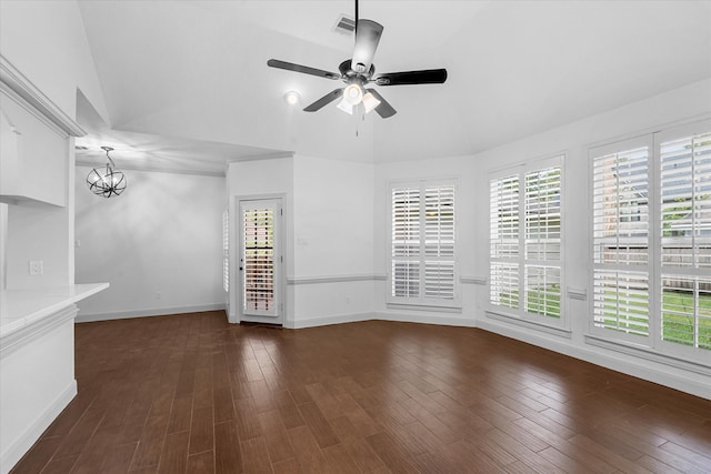 empty room featuring lofted ceiling, plenty of natural light, ceiling fan, and dark wood-type flooring