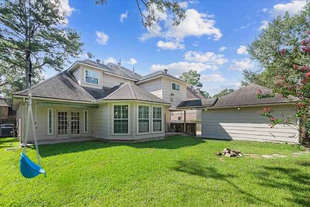 back of property with a yard and french doors