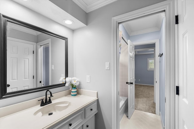 bathroom featuring tile patterned flooring, tiled shower / bath, crown molding, and vanity