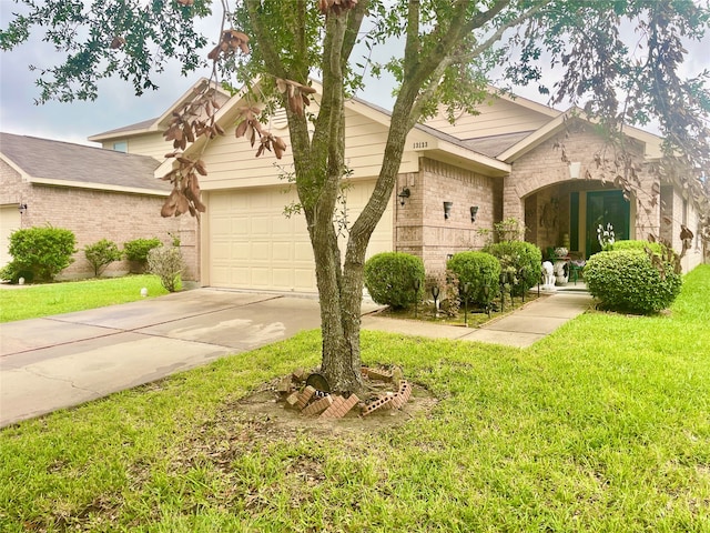 view of front of house with a garage and a front yard