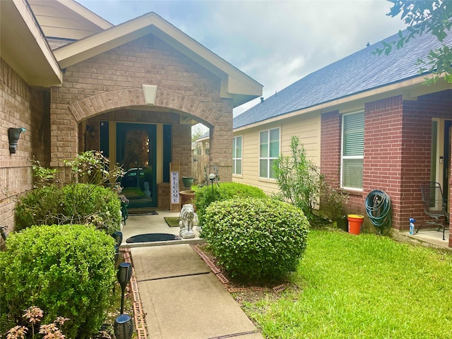 doorway to property with a lawn