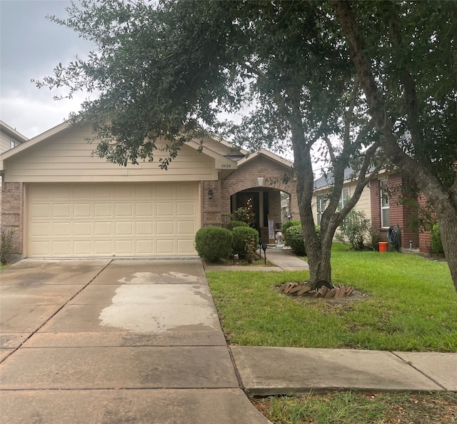 view of front of property featuring a garage and a front lawn