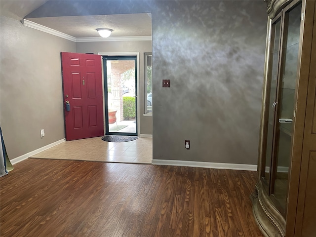 foyer featuring wood-type flooring and crown molding