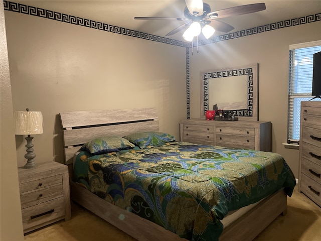 bedroom with ceiling fan and light colored carpet