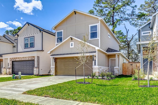 view of front of house featuring a garage, stone siding, concrete driveway, and a front yard