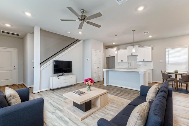 living room featuring recessed lighting, visible vents, light wood finished floors, and ceiling fan